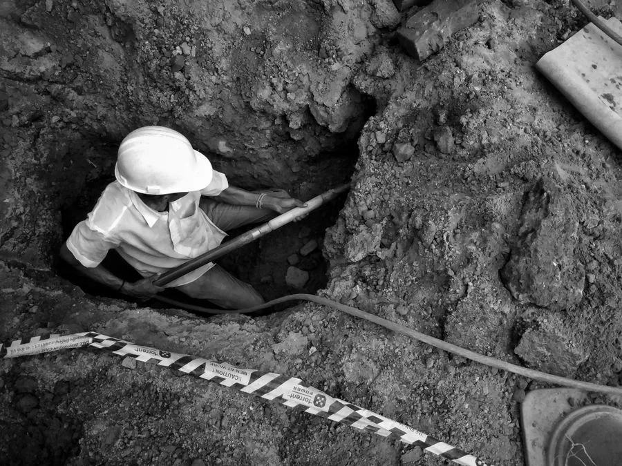 A worker in a trench at a construction site