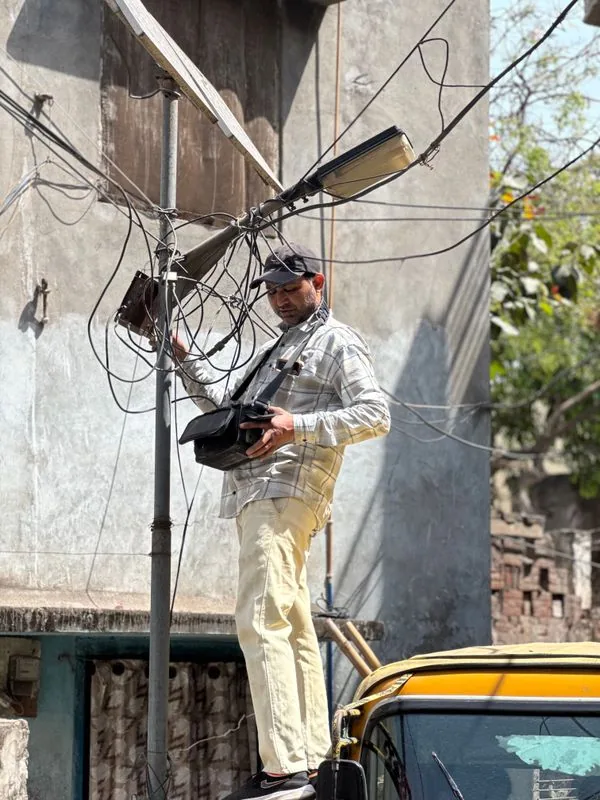 A technician repairing a streetlight in the city