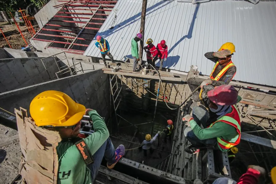 A crew in hard hats and high-visibility vests at work on a construction site