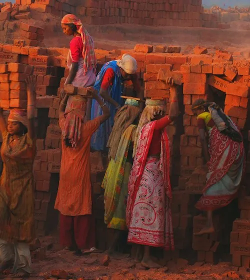 A woman worker at a brick wall